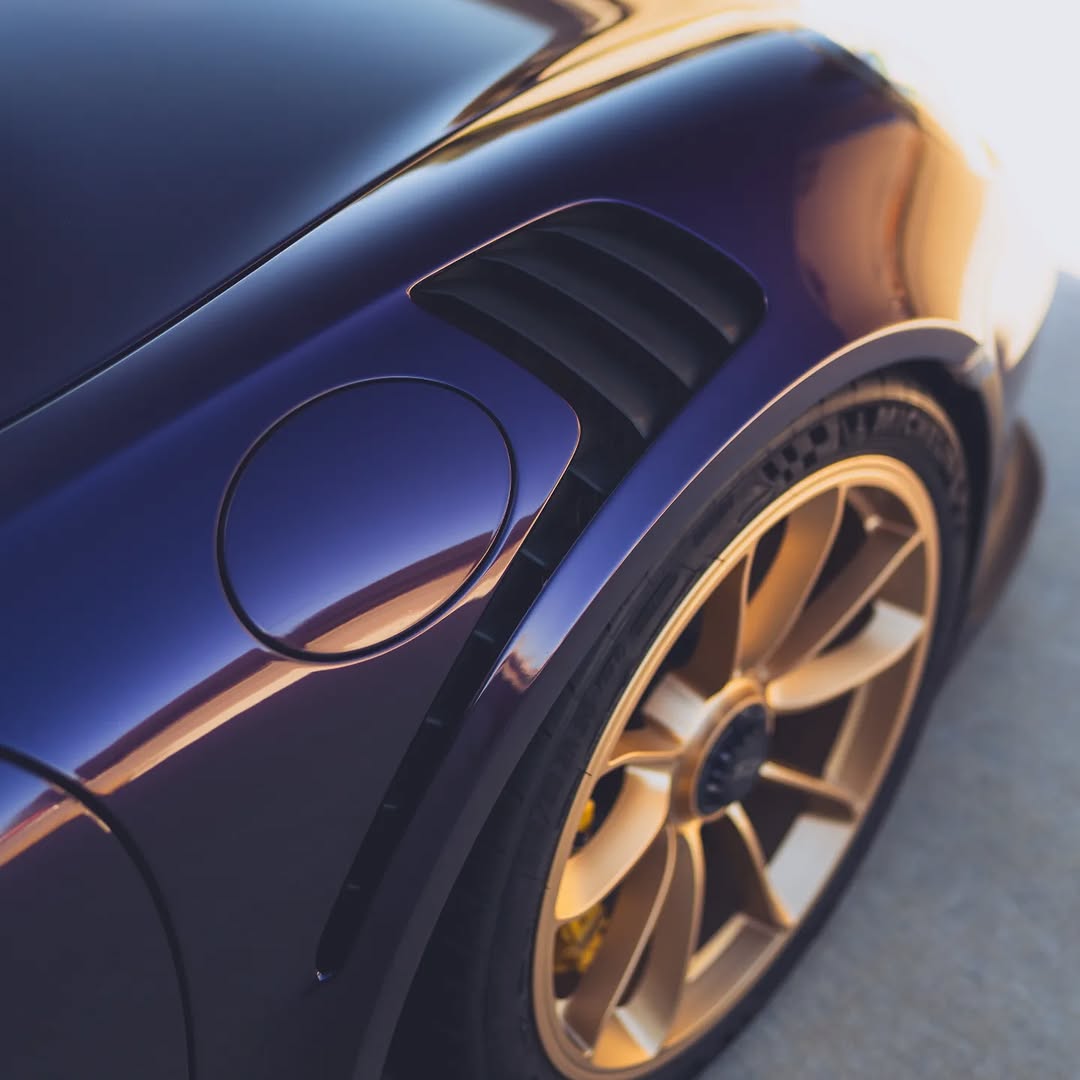 Sports car with a chameleon colour-change wrap on a concrete surface.